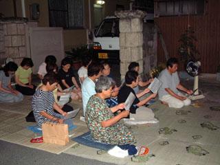 各々が祝詞や般若心経が書かれている紙を持ち、それを読み上げている時の村の人たちの写真