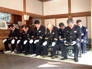 拝殿内にて神事に同席した正装の消防団員たちが拝礼している時の写真
